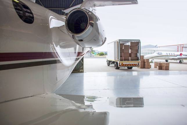 Airplane and truck being loaded with boxes-RXO