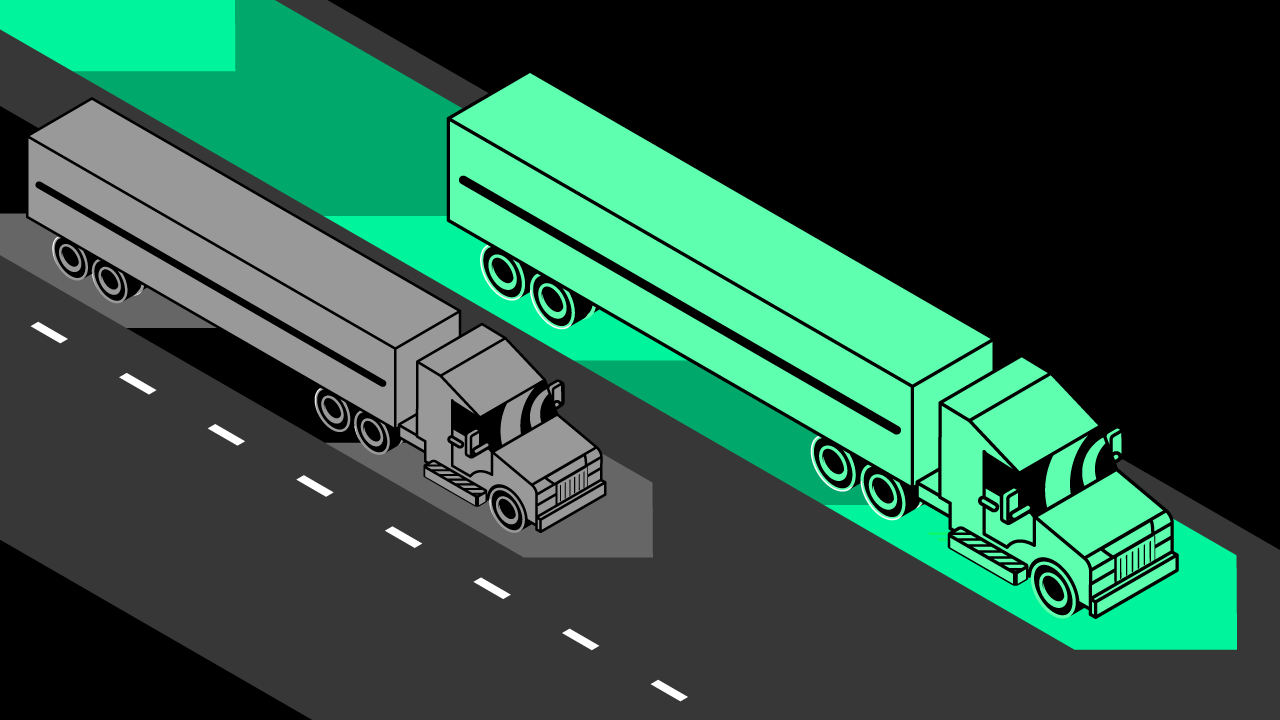 Two trucks, one gray one green